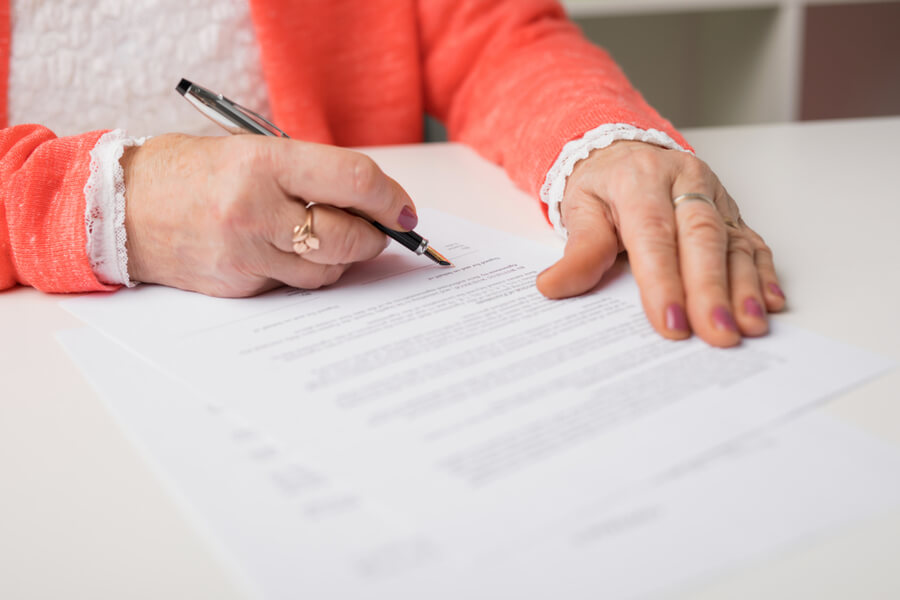 Woman signing a legal document